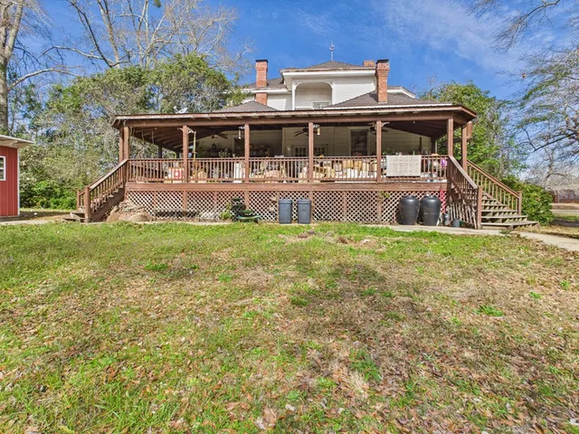 a backyard of a house with lots of green space and chair