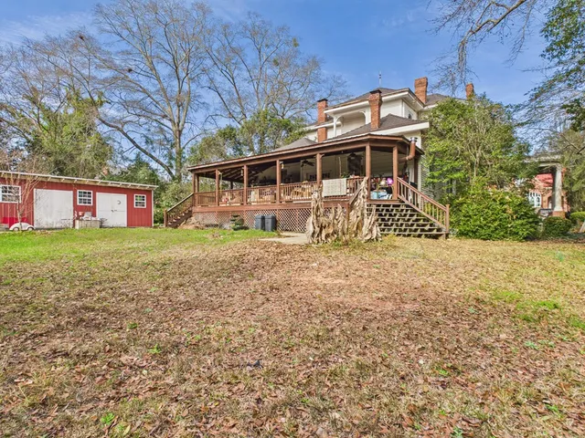 a living room filled with furniture and a chandelier