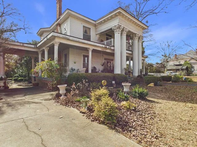 a view of a patio with table and chairs and potted plants