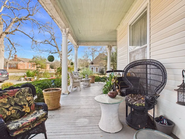 a living room with furniture and flowers
