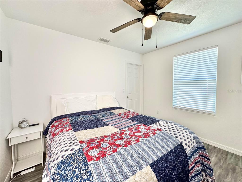 2120 Southwest 142nd Court Road Ocala, FL 34481 - Photo 13 of 14 a bedroom with a bed and a chandelier