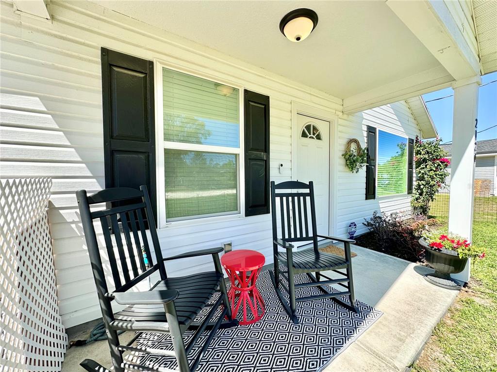 2120 Southwest 142nd Court Road Ocala, FL 34481 - Photo 4 of 14 a balcony view with a couch and potted plant