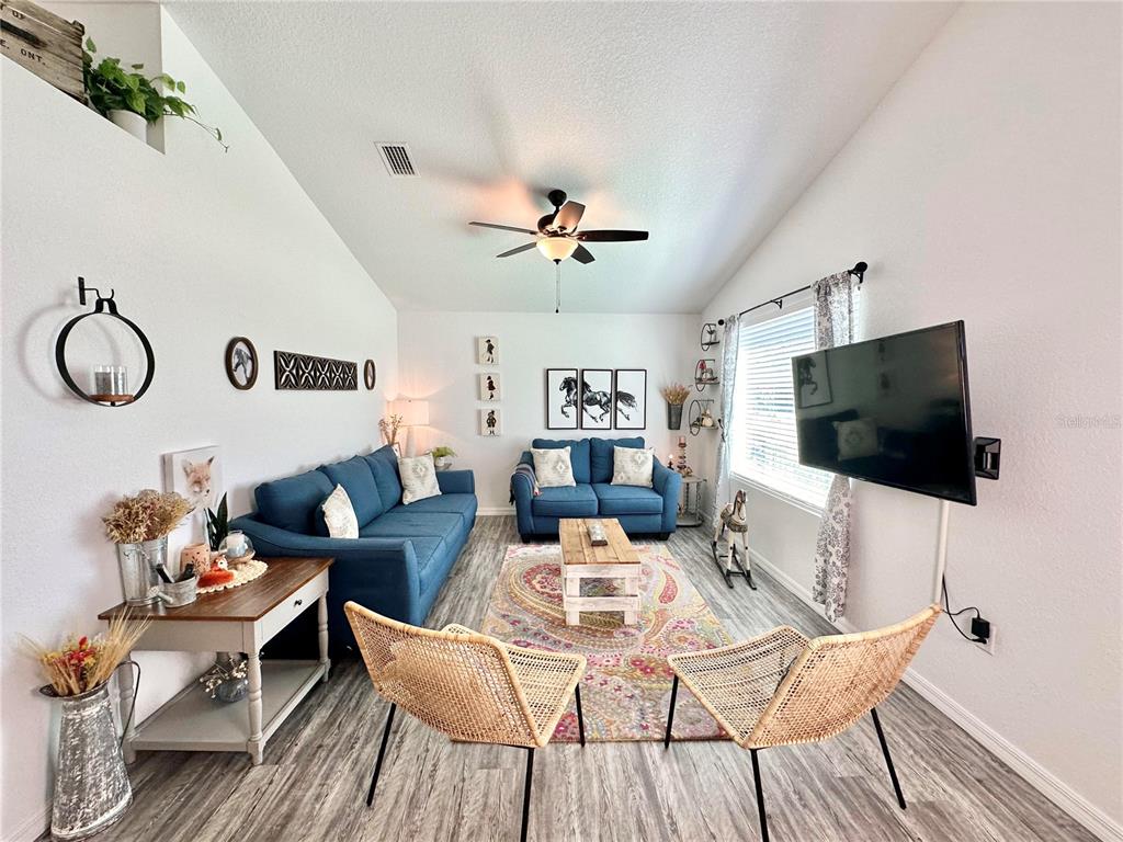 2120 Southwest 142nd Court Road Ocala, FL 34481 - Photo 6 of 14 a living room with furniture and a flat screen tv