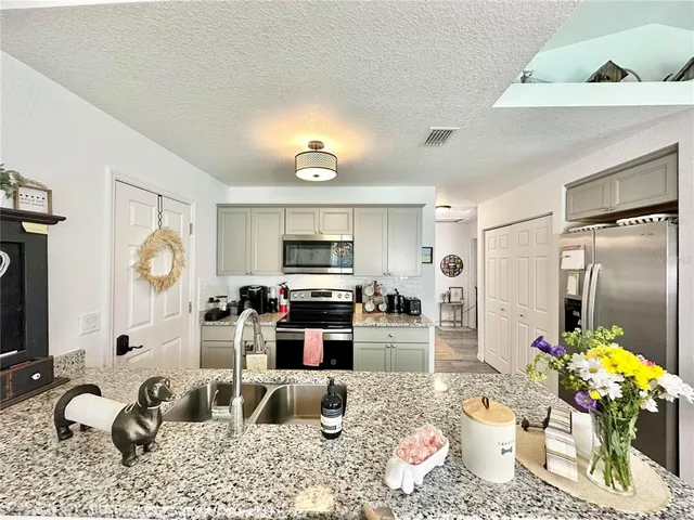 a living room with furniture a rug and a fireplace