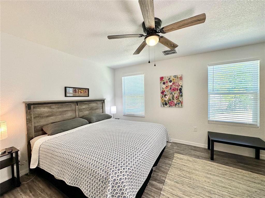 2120 Southwest 142nd Court Road Ocala, FL 34481 - Photo 10 of 14 a bedroom with a bed and a chandelier
