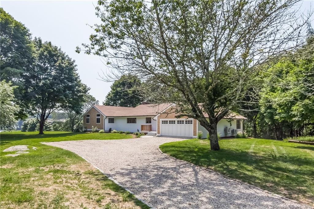 214 Cove Road Stonington, CT 06378 - Photo 1 of 1 a view of a house with a big yard and large trees