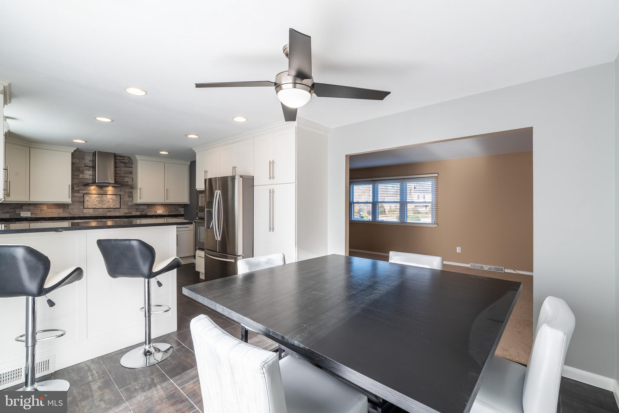 2703 Hunting Ridge Court Baldwin, MD 21013 - Photo 16 of 71 a kitchen with stainless steel appliances granite countertop a sink a stove a dining table and chairs