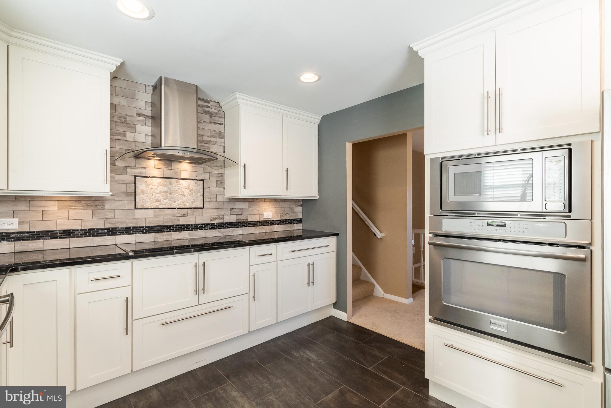 2703 Hunting Ridge Court Baldwin, MD 21013 - Photo 20 of 71 a kitchen with granite countertop white cabinets and stainless steel appliances