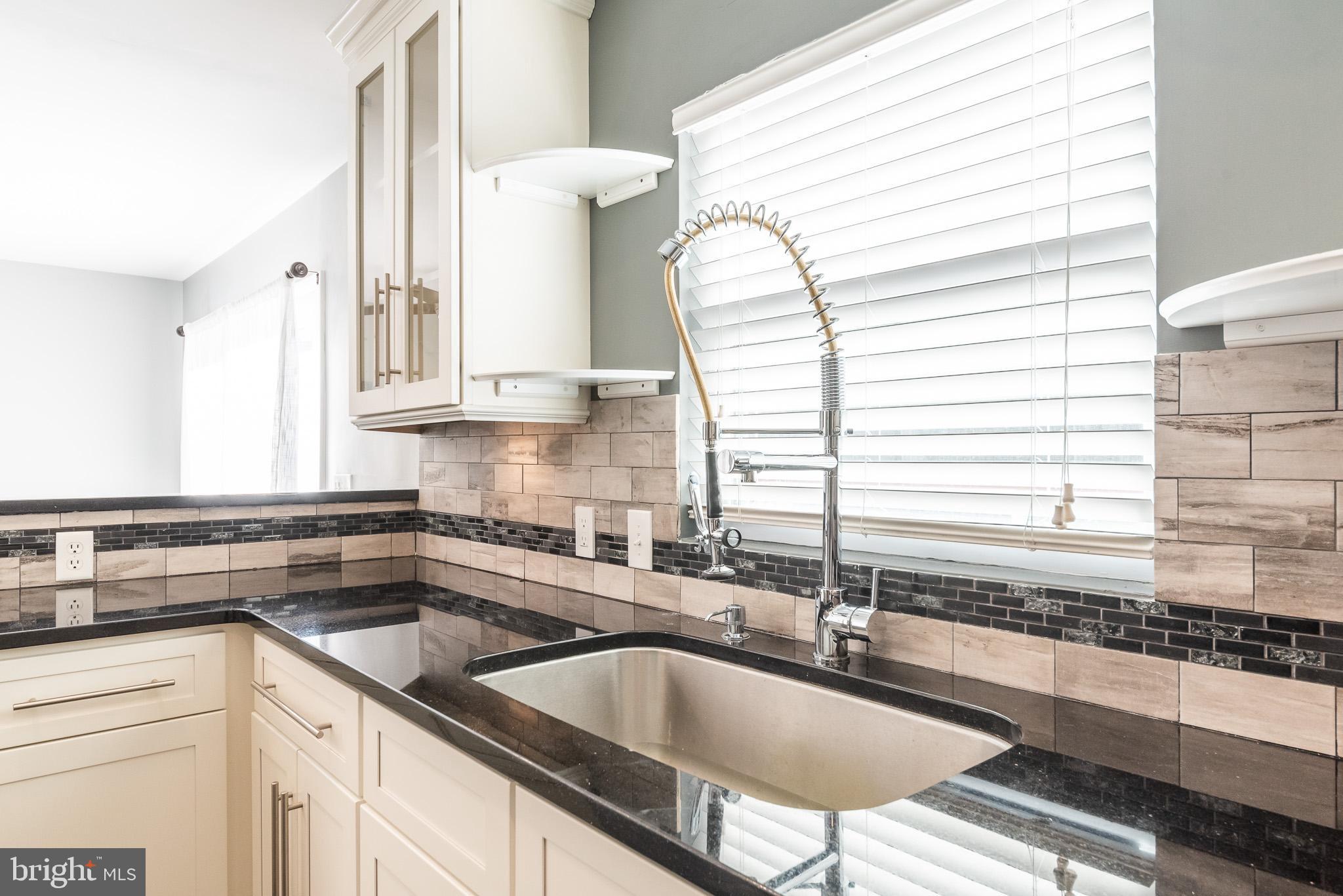 2703 Hunting Ridge Court Baldwin, MD 21013 - Photo 22 of 71 a kitchen with granite countertop a sink and a window