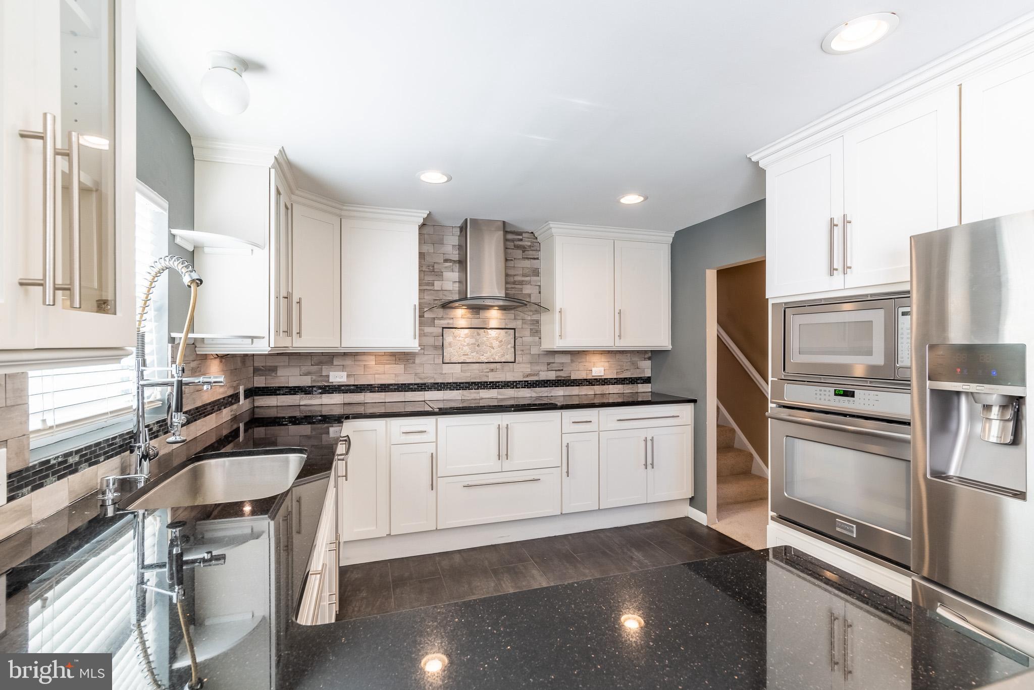 2703 Hunting Ridge Court Baldwin, MD 21013 - Photo 25 of 71 a kitchen with granite countertop cabinets stainless steel appliances a sink and a counter top space