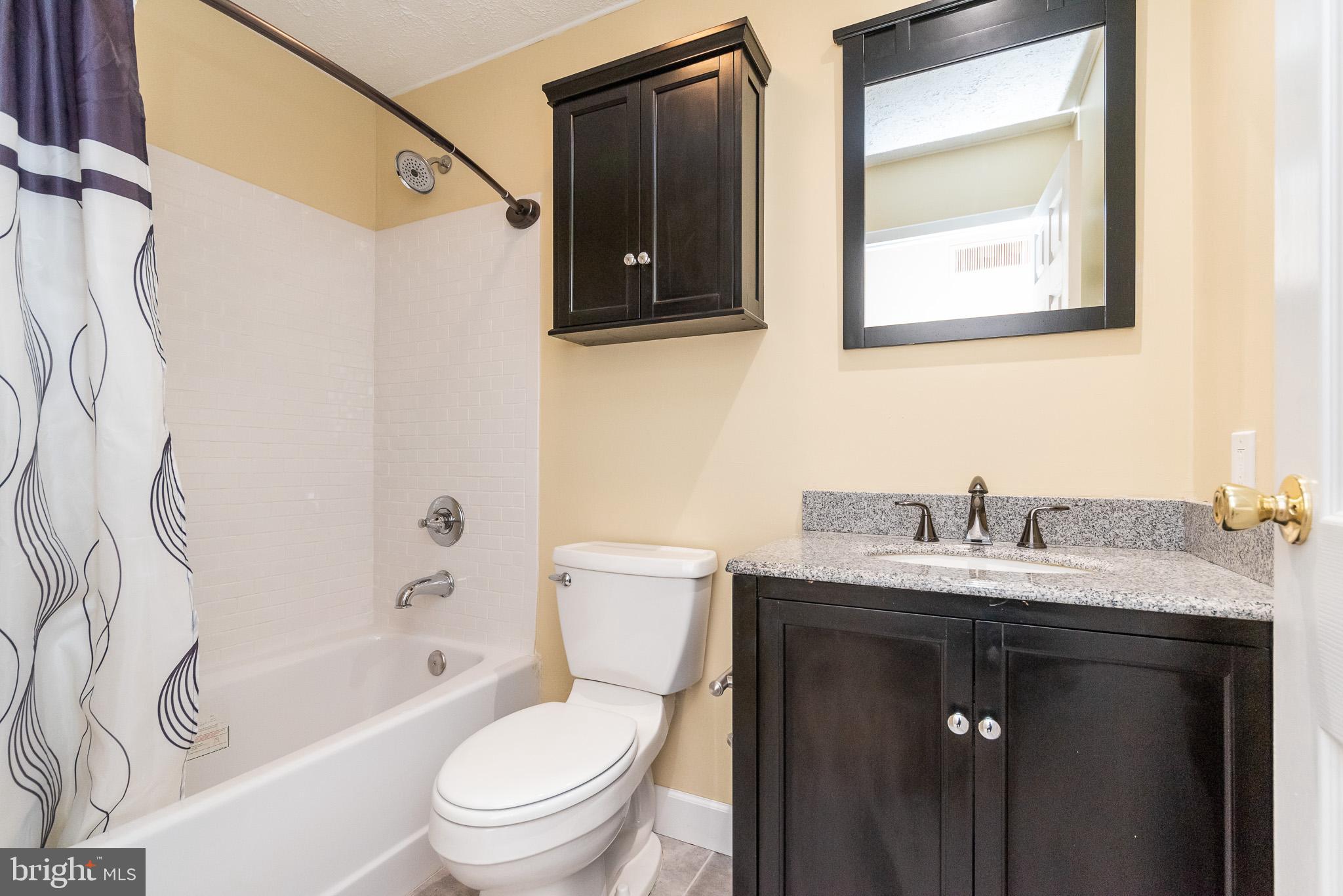 2703 Hunting Ridge Court Baldwin, MD 21013 - Photo 37 of 71 a bathroom with a granite countertop toilet sink and mirror