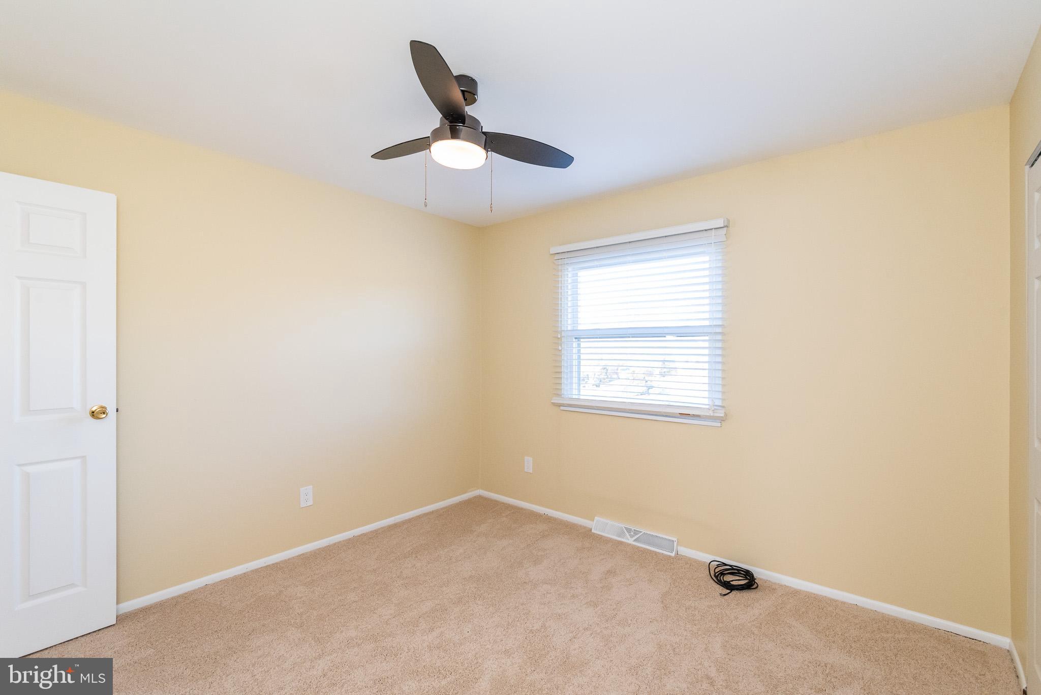 2703 Hunting Ridge Court Baldwin, MD 21013 - Photo 39 of 71 an empty room with a window and a ceiling fan