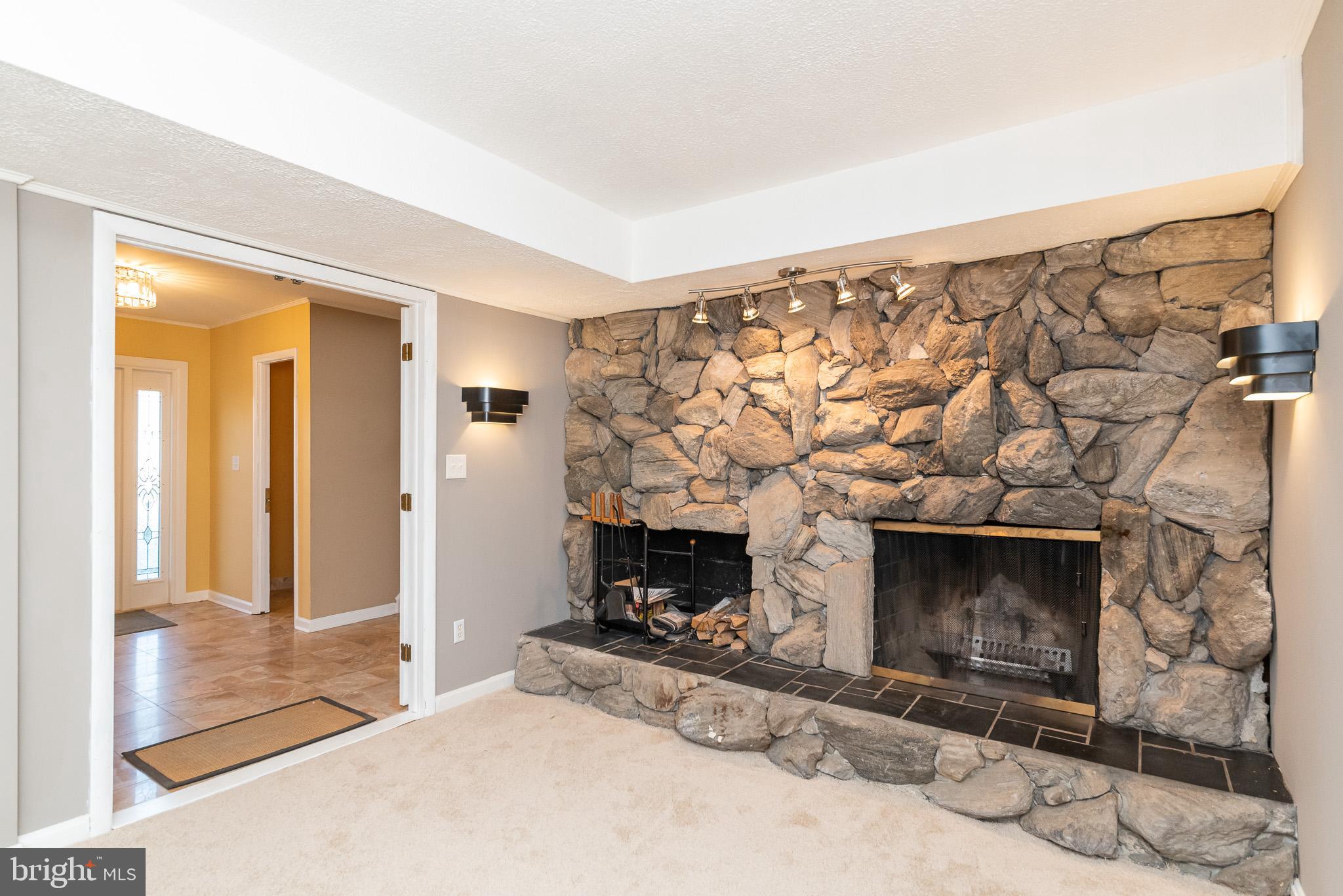 2703 Hunting Ridge Court Baldwin, MD 21013 - Photo 42 of 71 a living room with a fireplace with a wooden floor