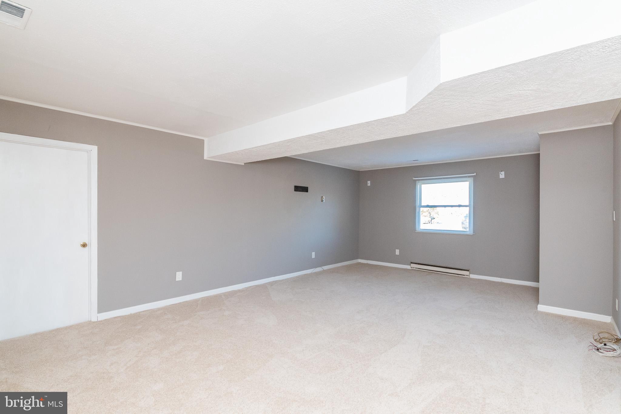 2703 Hunting Ridge Court Baldwin, MD 21013 - Photo 45 of 71 a view of an empty room with a window and wooden floor