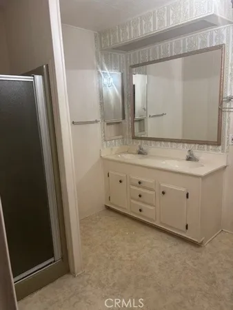 a bathroom with a double vanity sink and mirror