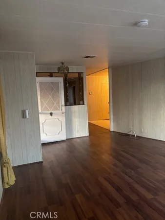 a view of a room with wooden floor and a sink