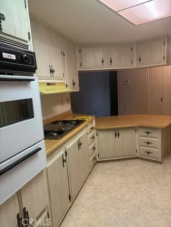 a kitchen with cabinets and white appliances