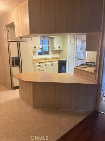 a kitchen with stainless steel appliances a refrigerator a sink and a stove