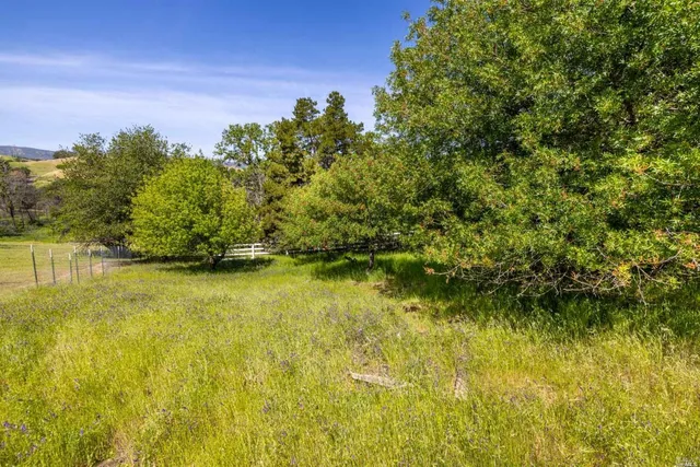 a view of a lake with a house in background