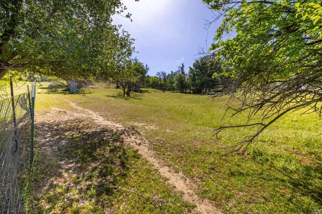 a view of a big yard with an outdoor space and seating area