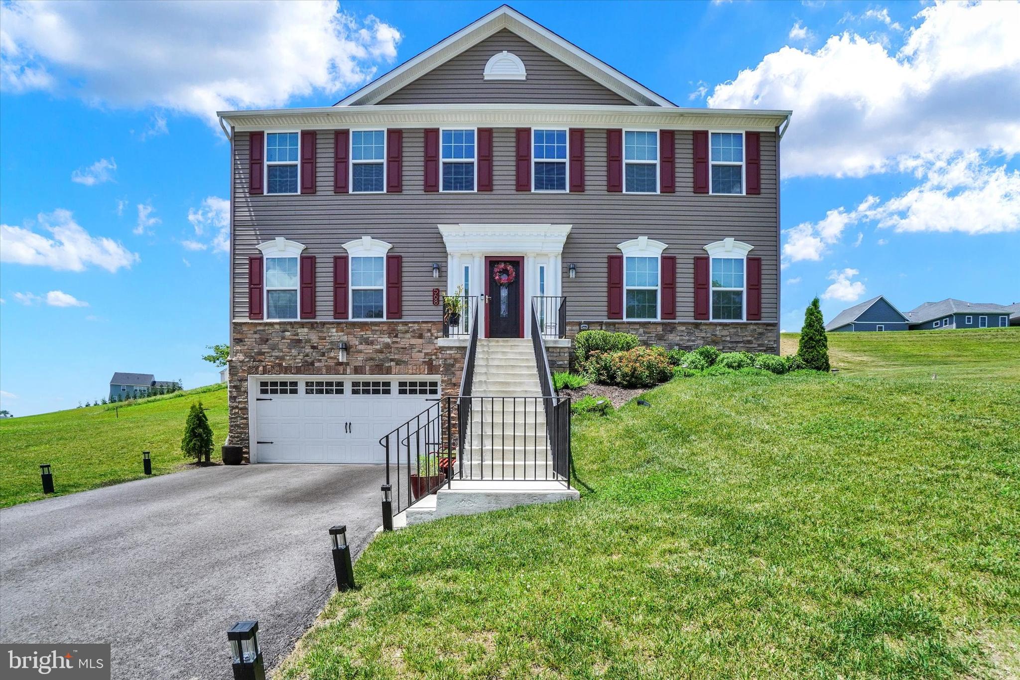 a front view of a house with a yard and garage