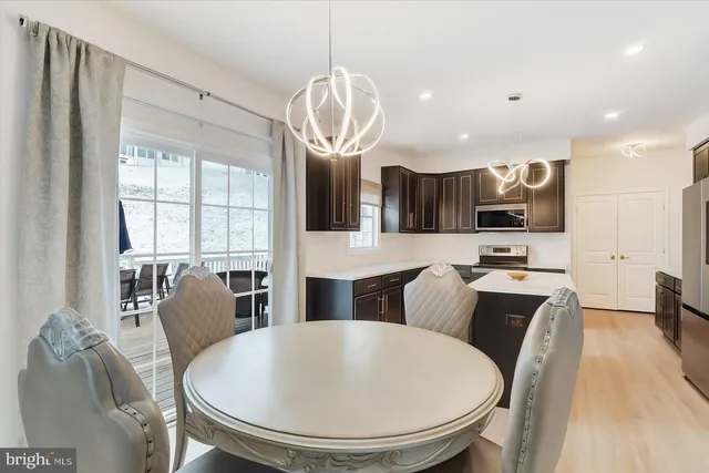 a large kitchen with a table and chairs