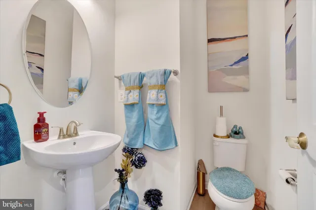 a bathroom with a sink toilet and mirror