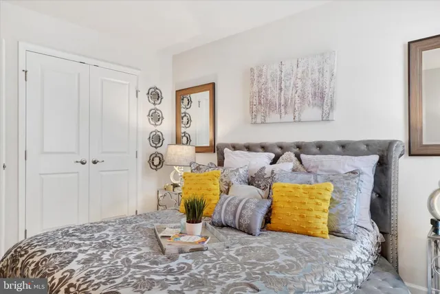 a white couch sitting in a living room next to a window