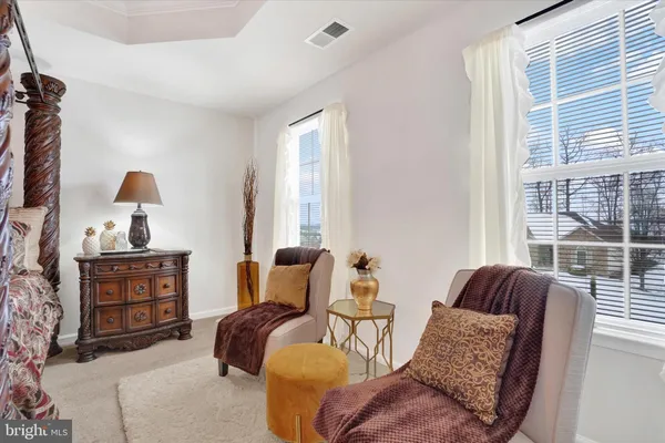 a living room with furniture a flat screen tv and gym equipment