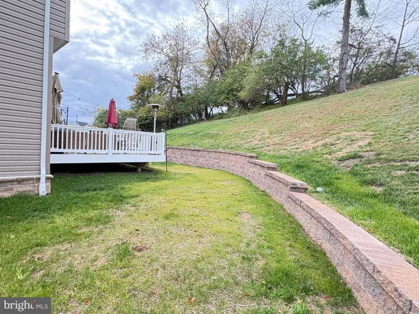 an aerial view of a house with a floor to ceiling window and outdoor seating