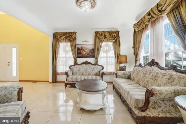 a living room with furniture and a chandelier