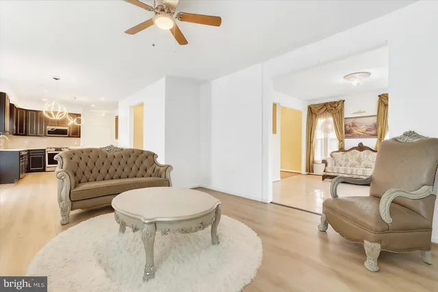 a living room with furniture and a chandelier