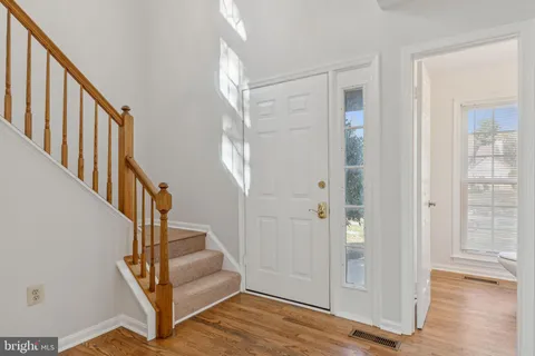 a view of an entryway with wooden floor and door