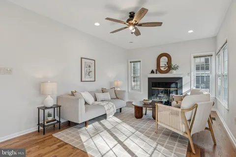 a living room with furniture a clock and a fireplace
