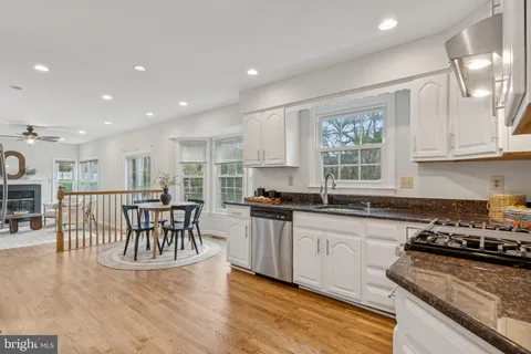 a kitchen with a table chairs stove and cabinets