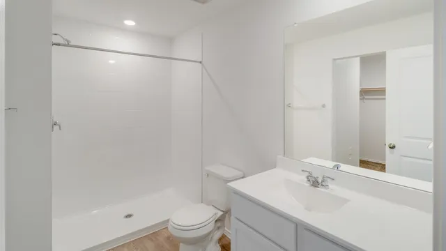 a bathroom with a sink toilet and shower
