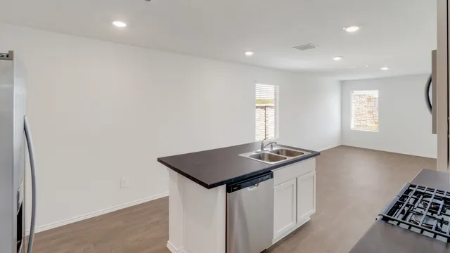 a kitchen that has a sink and a stove in it
