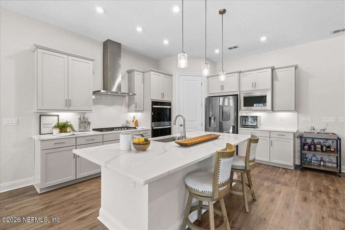80 Ridgehill Way St. Johns, FL 32259 - Photo 13 of 60 a kitchen with a sink a stove a refrigerator and chairs