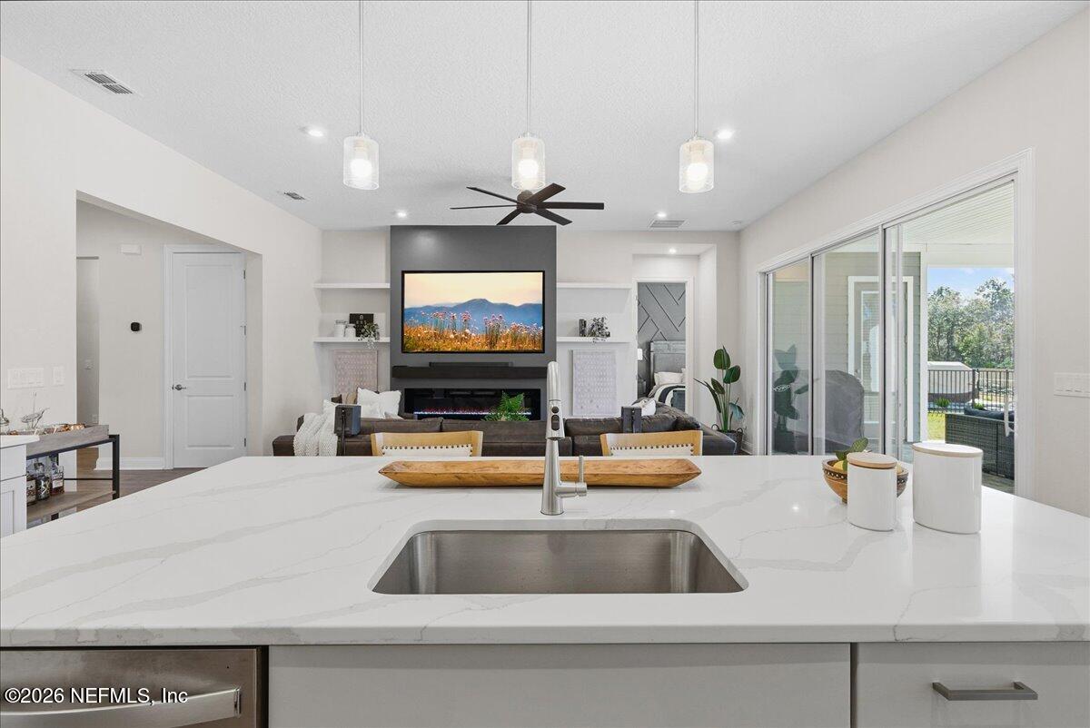 80 Ridgehill Way St. Johns, FL 32259 - Photo 15 of 60 a kitchen with a sink and a flat screen tv