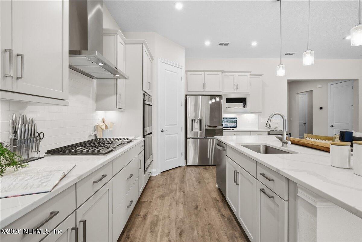 80 Ridgehill Way St. Johns, FL 32259 - Photo 16 of 60 a kitchen with stainless steel appliances granite countertop a sink stove and refrigerator