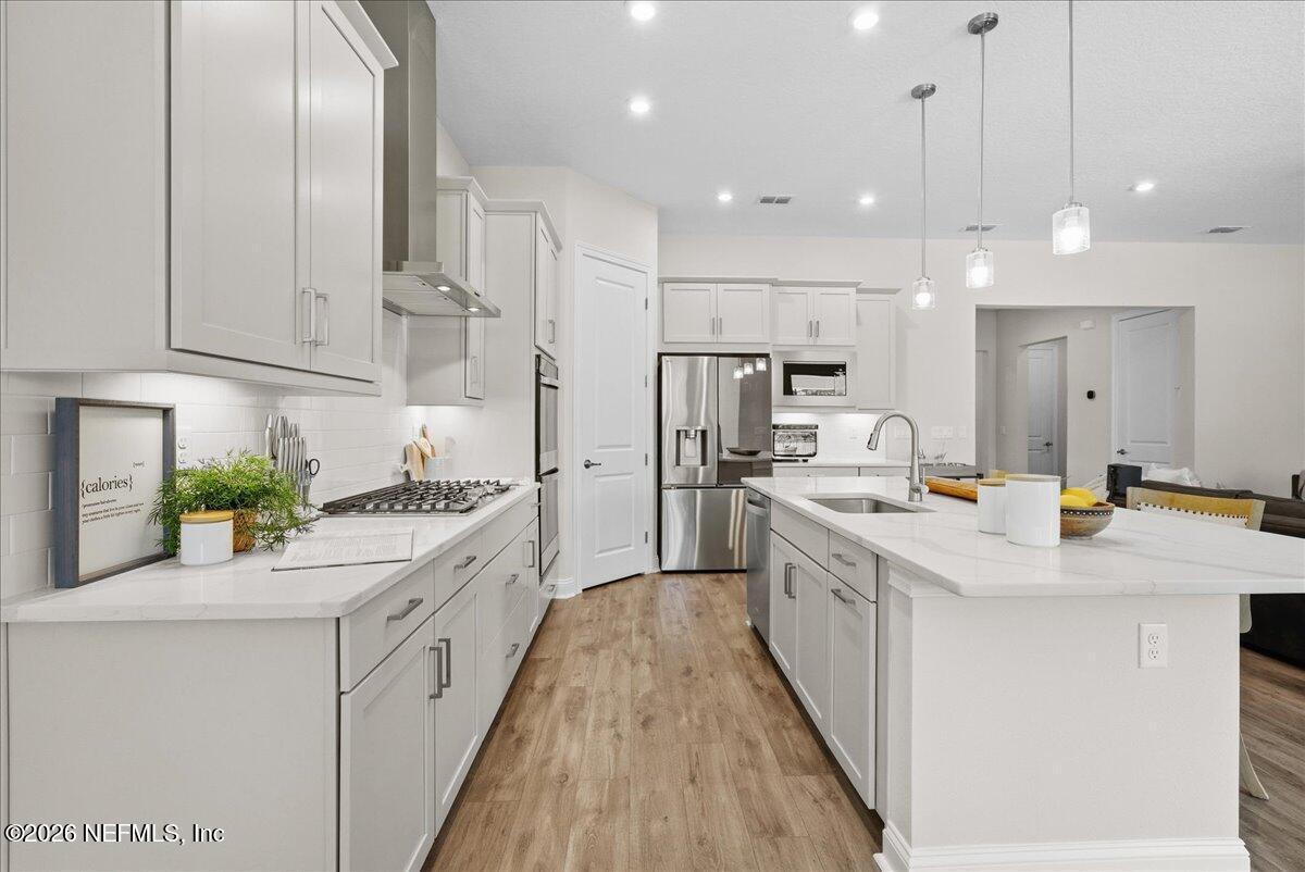 80 Ridgehill Way St. Johns, FL 32259 - Photo 17 of 60 a large kitchen with kitchen island a large counter top appliances and cabinets