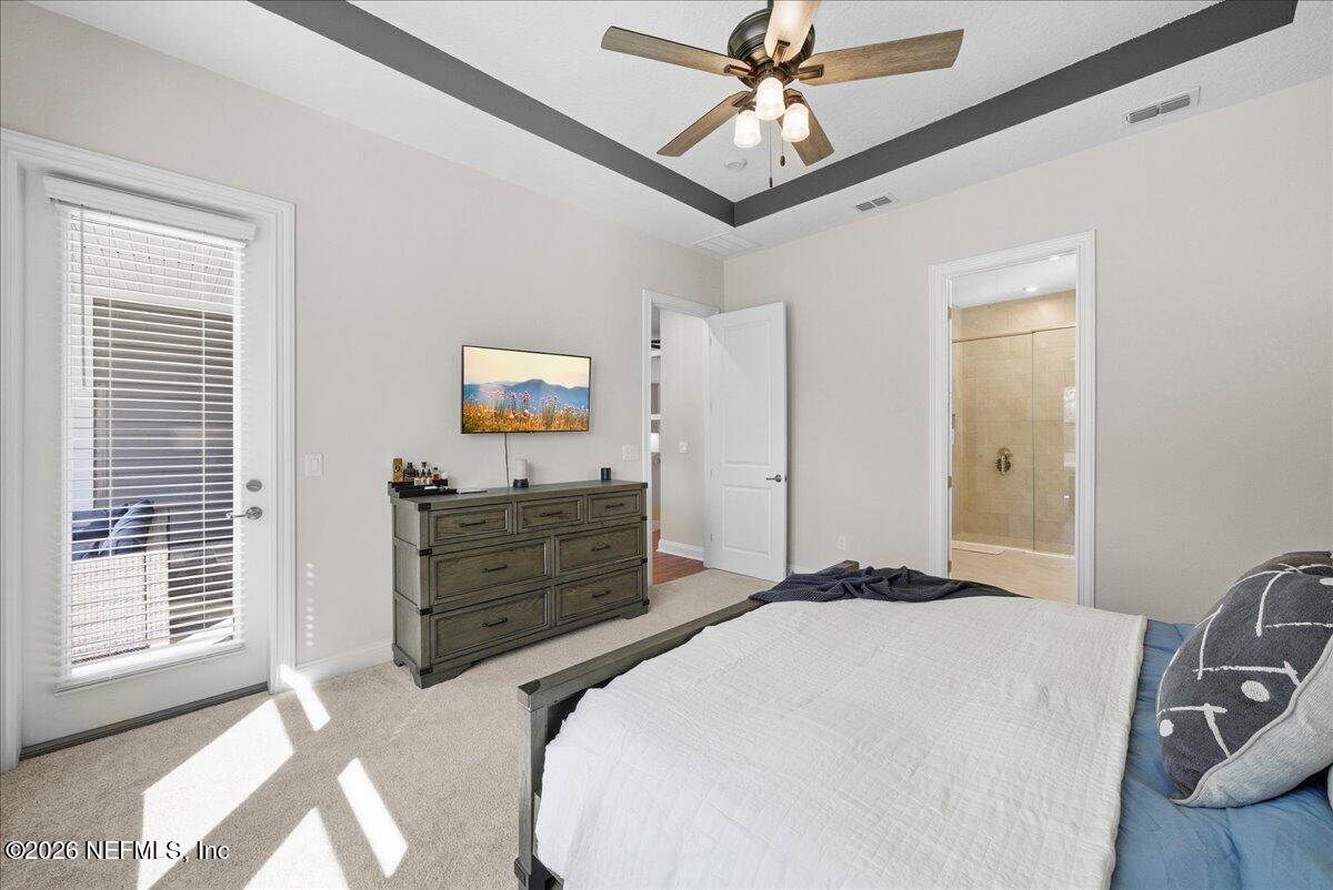 80 Ridgehill Way St. Johns, FL 32259 - Photo 22 of 60 a bedroom with a bed and a chandelier