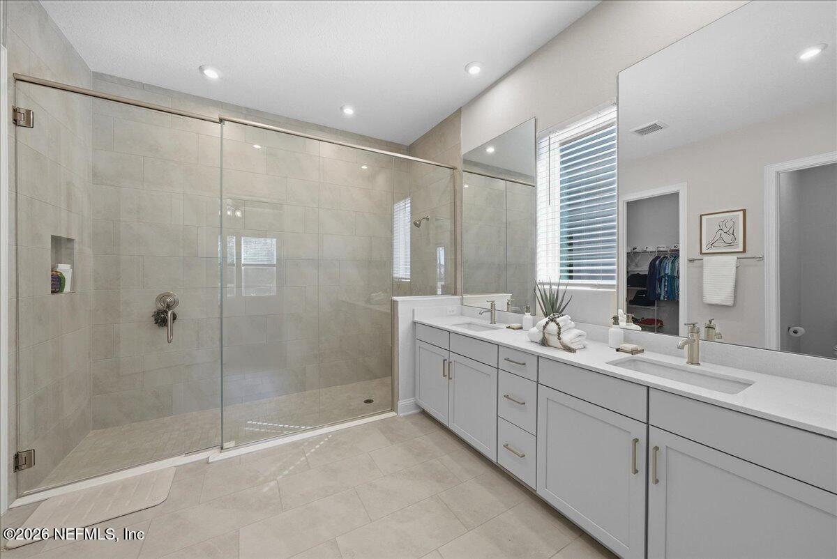 80 Ridgehill Way St. Johns, FL 32259 - Photo 23 of 60 a bathroom with a double vanity sink mirror and shower