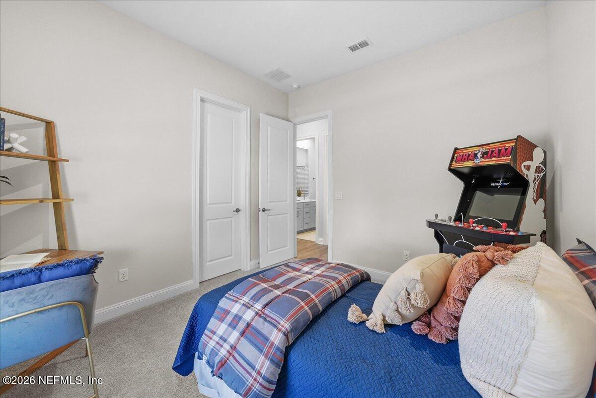 80 Ridgehill Way St. Johns, FL 32259 - Photo 30 of 60 a bedroom with a bed and wooden floor