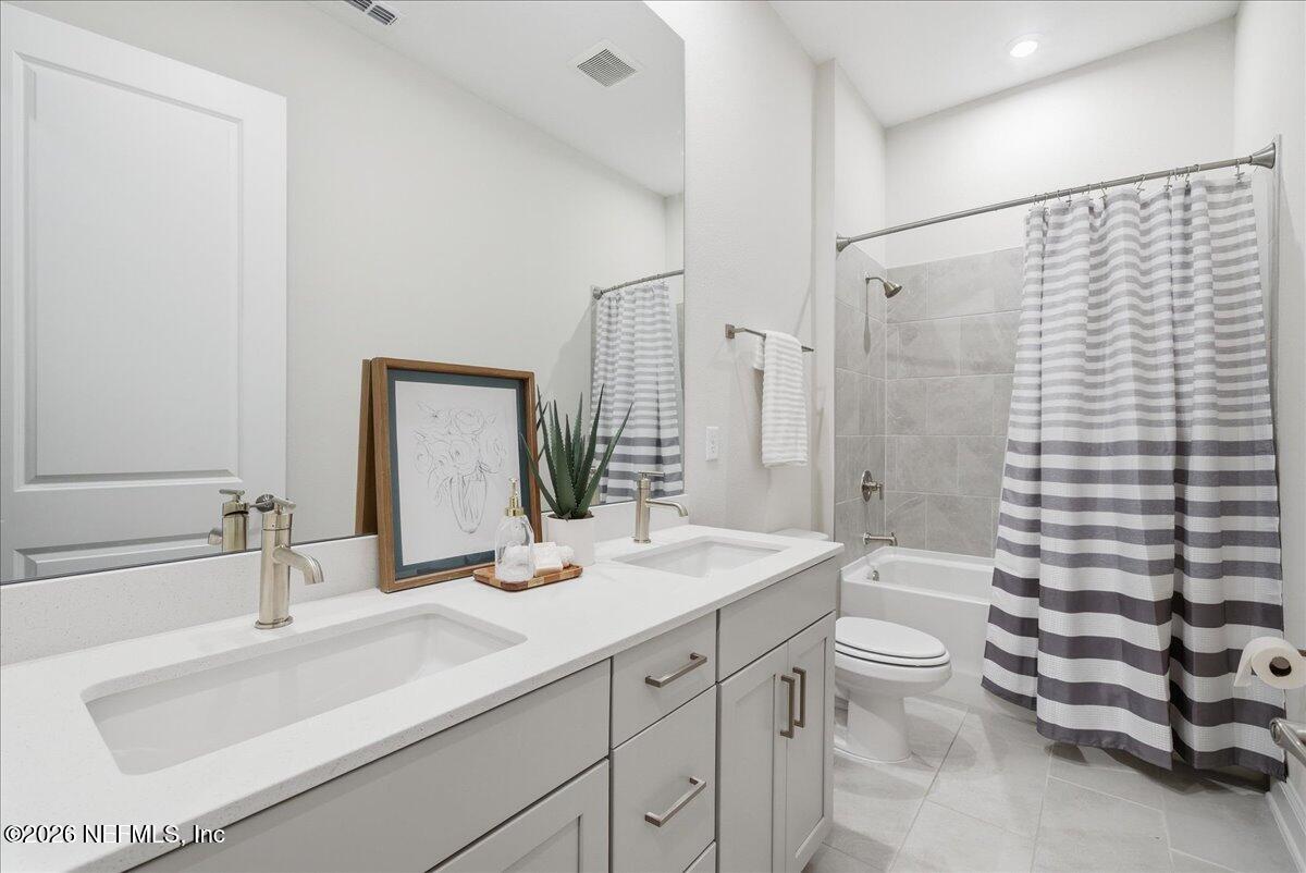 80 Ridgehill Way St. Johns, FL 32259 - Photo 31 of 60 a bathroom with a double vanity sink toilet mirror and shower