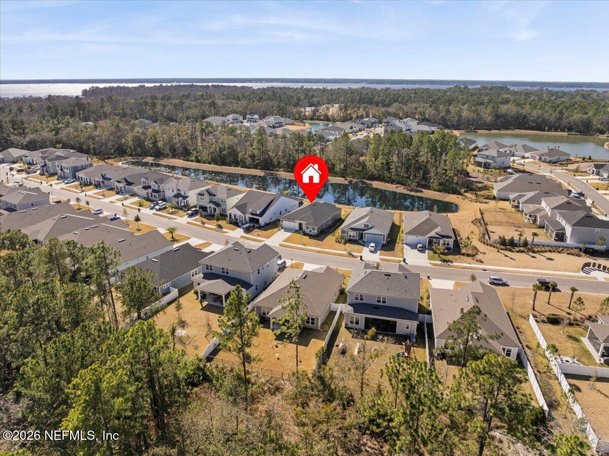 80 Ridgehill Way St. Johns, FL 32259 - Photo 57 of 60 an aerial view of a house with a yard and lake view