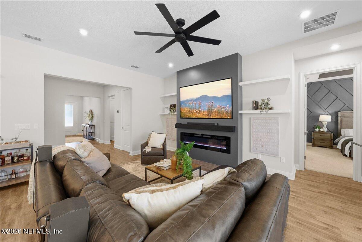 80 Ridgehill Way St. Johns, FL 32259 - Photo 10 of 60 a living room with furniture a flat screen tv and a fireplace