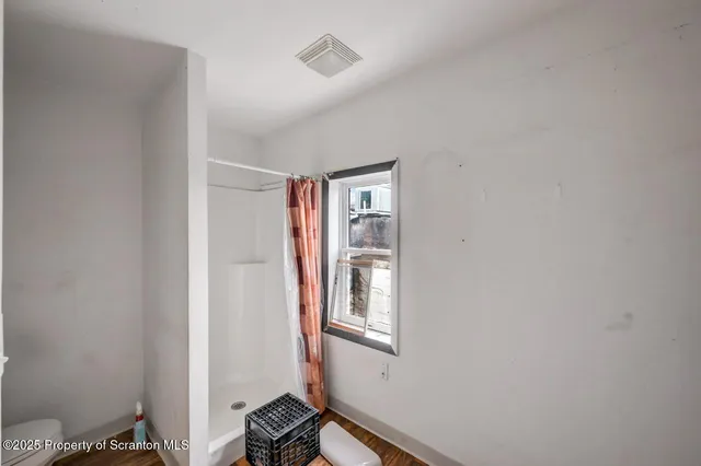 a bed room with a bed and a window