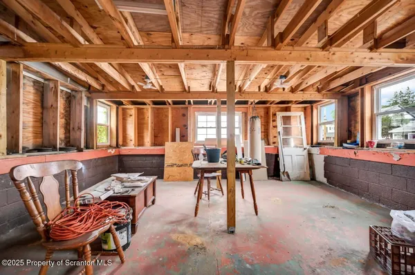 a living room with furniture a flat screen tv and windows