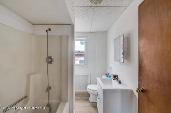 a view of a hallway with workspace and a window